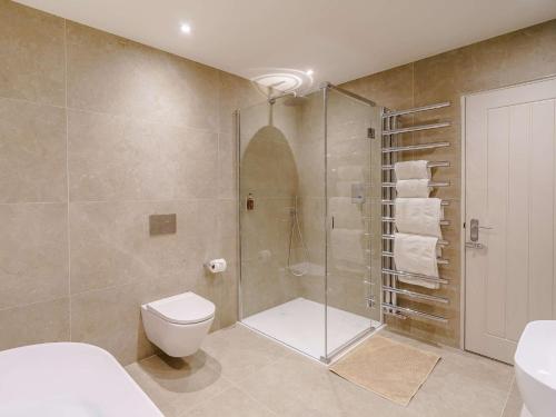 a bathroom with a shower and a toilet and a sink at 1 Bed in Ambleside 90636 in Ambleside