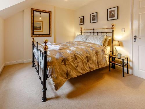 um quarto com uma cama e um espelho na parede em 3 Bed in Matlock 90663 em Matlock