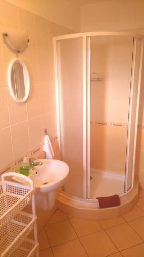 a bathroom with a shower and a sink at Penzión Aqua in Liptovský Mikuláš