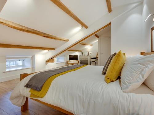 a bedroom with a large white bed with yellow pillows at 3 Bed in Hawes 90749 in Hawes