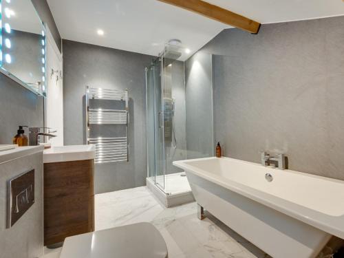 a bathroom with a tub and a sink and a shower at 3 Bed in Hawes 90749 in Hawes