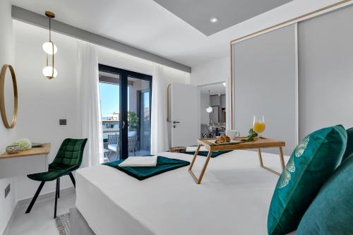 a bedroom with a white bed and a table at Villa Bomada in Tučepi