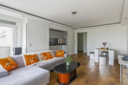 un salon avec un canapé et une table dans l'établissement Appartement Rodina - Welkeys, à Issy-les-Moulineaux
