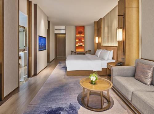 a hotel room with a bed and a couch at Crowne Plaza Chengdu Wuhou by IHG in Chengdu