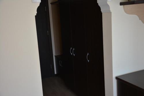 a black cabinet in a room with a hallway at Yavuzhan Hotel in Side