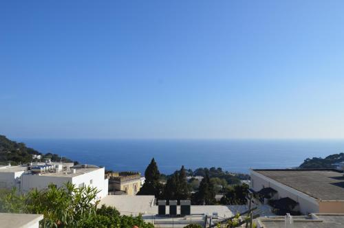 a view of the ocean from the roofs of buildings at Villa La Panoramica Sea View in Capri