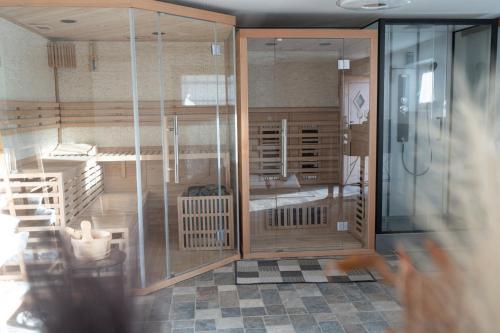 a room with glass doors and a room with a bed at Steindl Hütte in Deutschfeistritz