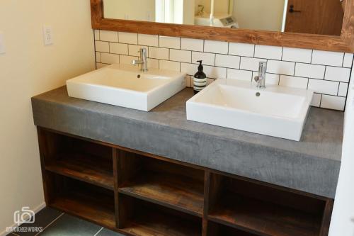two sinks on a counter in a bathroom at The Lake House 野尻湖 in Shinano