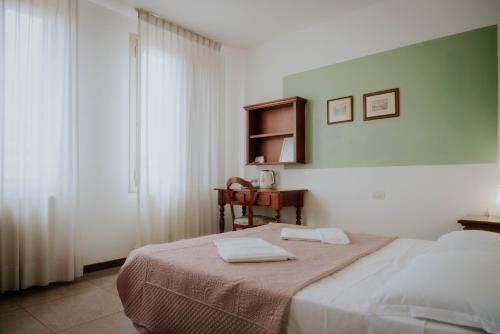 a bedroom with a bed with two towels on it at Casa Accademia in Venice