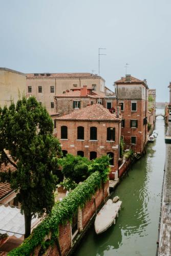 a view of a canal with boats in the water at Casa Accademia in Venice