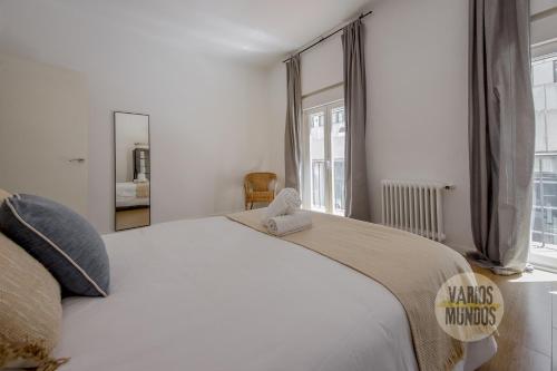 a bedroom with a large white bed and a window at Stunning Apt en la Gran Via-Centro de Madrid in Madrid