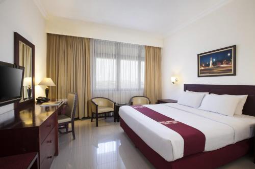 Llit o llits en una habitació de MMUGM Hotel