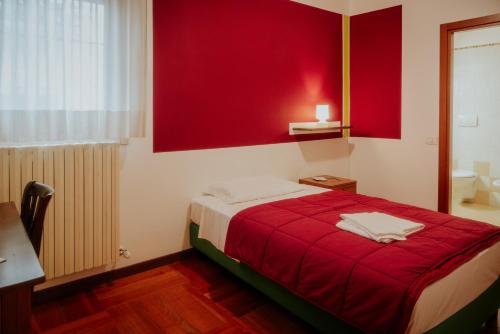 a red bedroom with a bed with a red wall at Casa Accademia in Venice