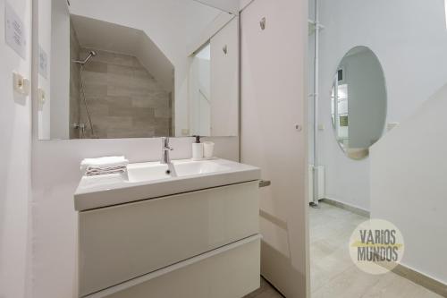 a white bathroom with a sink and a shower at Stylish Loft with 2 beedrooms en el Centro - La Latina in Madrid