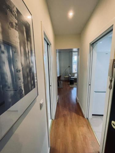 a hallway leading to a living room with a door at New Stylish Apt 5pax en la Plaza de Espana in Madrid
