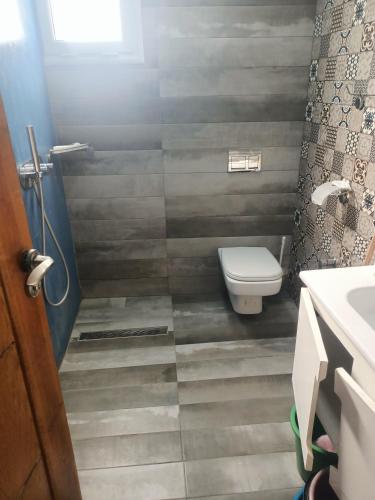 a bathroom with a toilet and a sink at dar el souk in Djerba