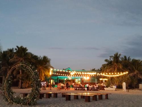 a restaurant on the beach at night with a christmas decorations at Oceanfront Casa Rhino in Paso Hondo
