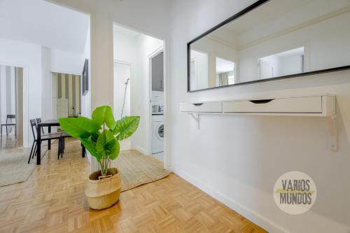 uma sala de estar com um espelho e um vaso de plantas em Practico Apt 7pax en Calle Santa Ana Centro de Madrid em Madrid