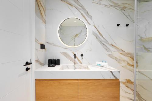 a bathroom with a sink and a mirror at Lavish Living in Dubai Marina's Finest 2 bedroom in Dubai