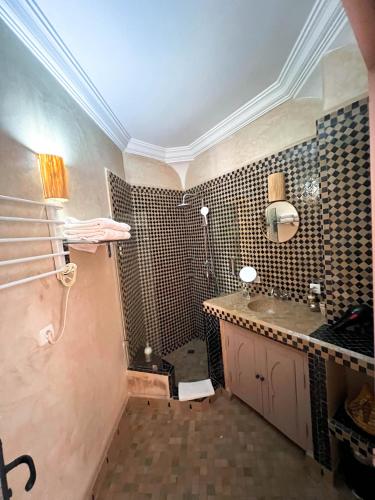 a bathroom with a sink and a shower in it at Riad Jonan & Spa in Marrakech