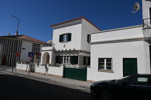 a white house with a car parked in front of it at Villa Sor in Ponte de Sor