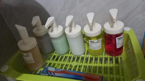 a green plastic container with four bottles of paint at SECLUDED GLAMPING YOGA SAMADHI fan 2 kubos 8 pax in Rimus