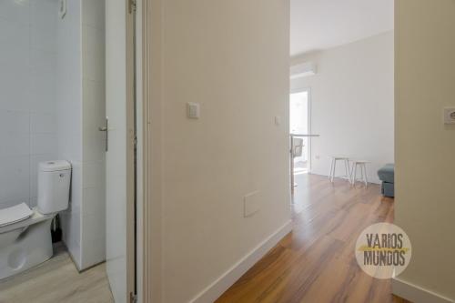 a white room with a refrigerator and a wooden floor at Downtown Apt 1hab para 3pax en la Plaza de Chueca in Madrid