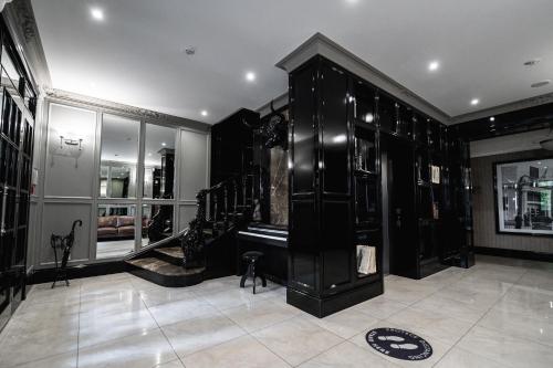 a room with black cabinets and a tiled floor at Wall Street Maestro in Odesa