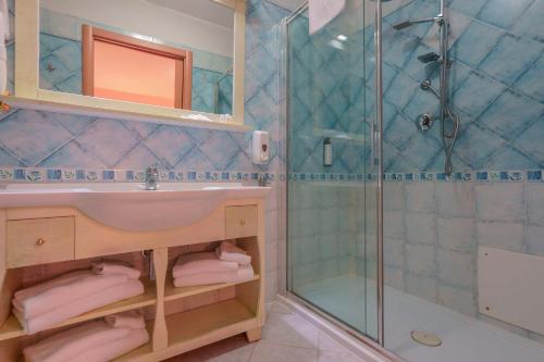 a bathroom with a sink and a shower at Hotel Solanas in Solanas