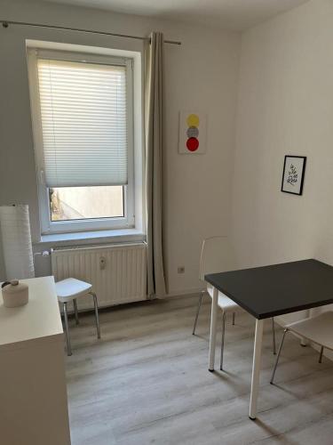 a room with a table and chairs and a window at Pension Christianstraße in Bernburg