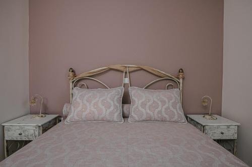 a bedroom with a bed with two night stands at Nereides Luxury Villas in Káto Almirí