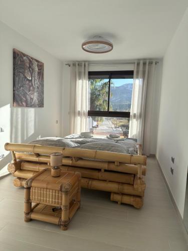 a bedroom with a large bed and a window at Las Lomas Denia I Les Deveses in Denia