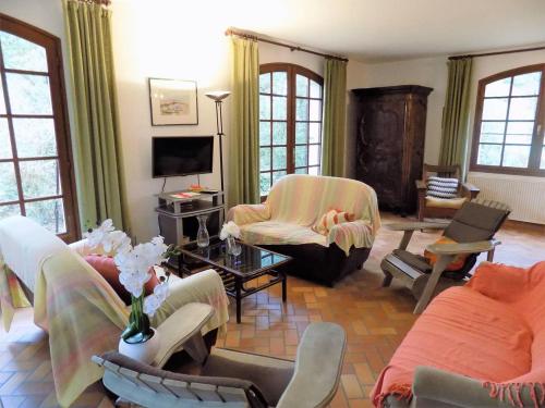 a living room with couches and chairs and a tv at La Palmyre - MAISON INDIVIDUELLE - PARC de la RESIDENCE - WIFI in Les Mathes