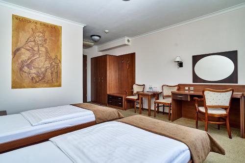 ティヒにあるHotel Stara Pocztaのベッドルーム1室(ベッド2台、デスク、テーブル付)