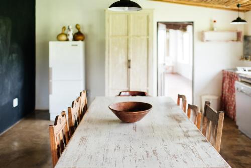 a wooden bowl on a wooden table in a kitchen at The Cowshed in Lydenburg