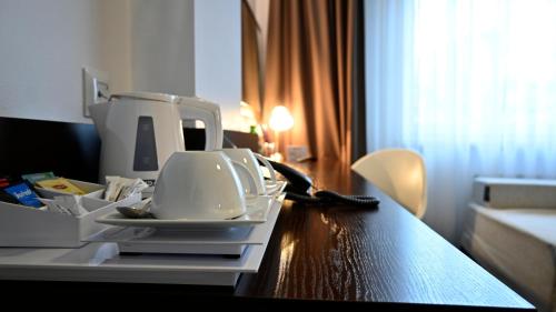 a table with a sewing machine on top of it at Vestil Hotel in Piotrków Trybunalski