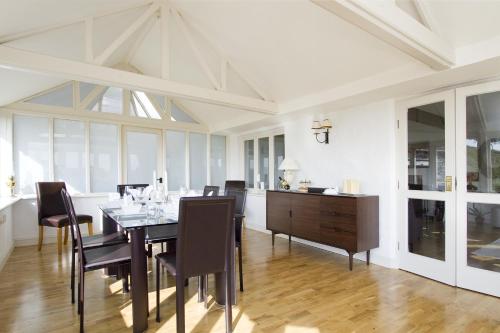 a dining room with a table and chairs at High Grassings Country House in Ambleside