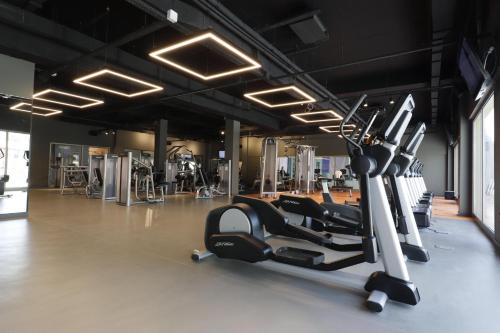 a gym with several treadmills and elliptical machines at Aqua Fantasy Aquapark Hotel & Spa - Ultra All Inclusive in Kusadası
