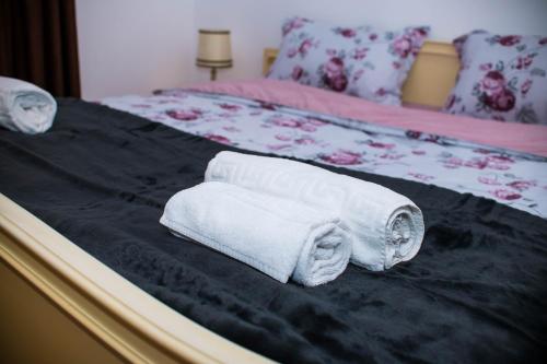 two rolls of towels sitting on a bed at Studio Sonia - Tordosan Central - #2 in Sibiu