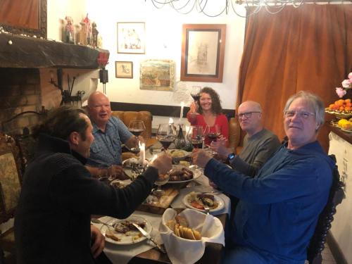 a group of people sitting around a table eating food at Chez les artistes in Servian