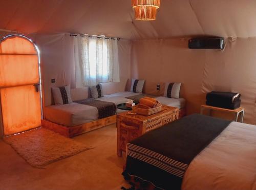 ein Schlafzimmer mit einem Bett und einem Sofa in der Unterkunft Night sky luxury camp in Adrouine