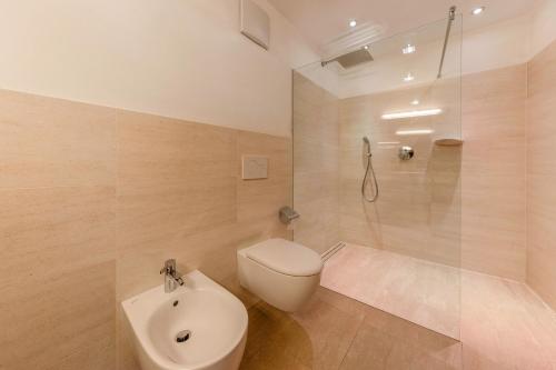 a bathroom with a toilet and a glass shower at Naturoase Stegerhof Apt Iris in Trodena