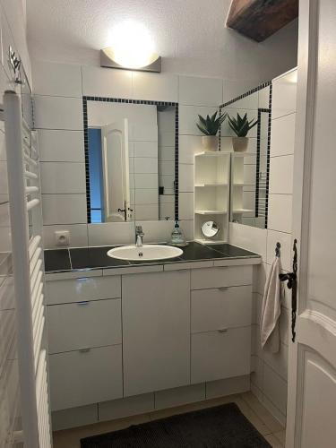 une salle de bain avec un lavabo et un miroir dans l'établissement Villa Florence, à Cavalaire-sur-Mer