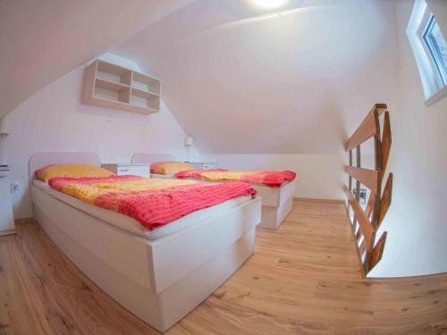 two beds in a room with a staircase at Apartment &Scaron;mon in Kranjska Gora