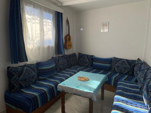 a living room with a couch and a table at Dar Fatima in Chefchaouene