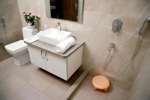 a bathroom with a sink and a shower and a toilet at Fortune Home Service Apartment 3Bhk,E-28, Saket 2B in New Delhi