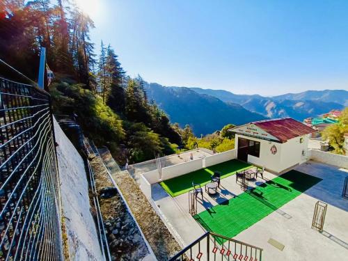 an aerial view of a house with a tennis court at The Regency by Boho Stays in Shimla