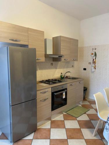 a kitchen with a stainless steel refrigerator and a stove at Torrione view apartment in Spilamberto
