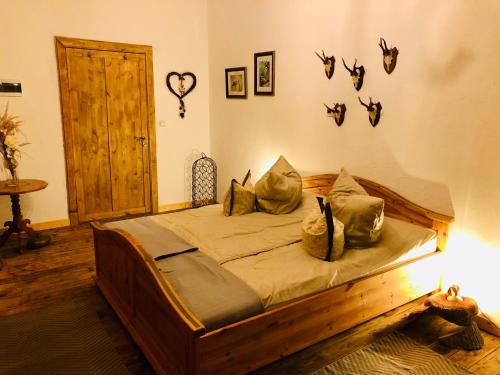 a bedroom with a wooden bed with pillows on it at Jägerwohnung in Süderholz