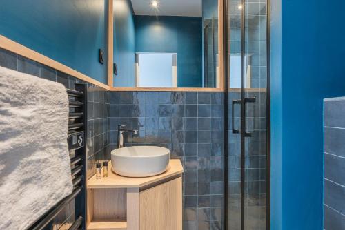 a bathroom with a sink and a shower at Design Architect Flat - 15min. from Paris center in Gentilly